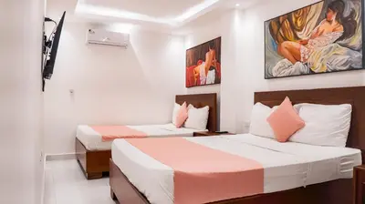 two beds in a hotel room with two beds at Cataleya Hotel in Santo Domingo