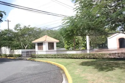 a house on a street with a yellow curb at Bellomar I Exclusive Juan Dolio Playa Hemingway in Juan Dolio