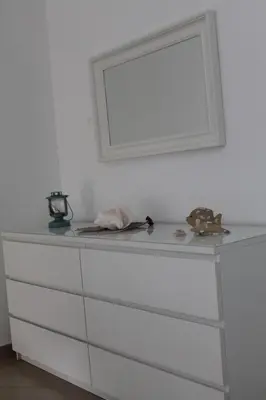 a white dresser with a mirror on a wall at B&B Villa Luna in Bayahibe