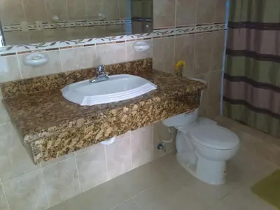 a bathroom with a sink and a toilet at La Ensenada Boutique Hotel in Punta Rucia