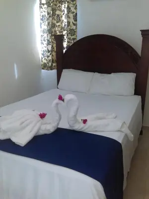 two swansuitsrendered to look like towels on a bed at La Ensenada Boutique Hotel in Punta Rucia