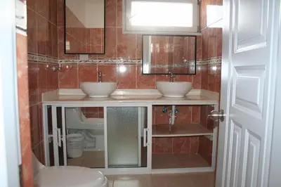a bathroom with two sinks and a toilet at Villas Michaela Caribbean in Sosúa