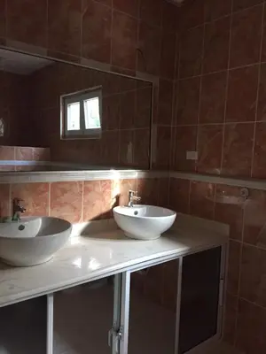 a bathroom with two sinks and a mirror at Villas Michaela Caribbean in Sosúa