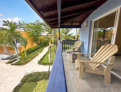 two chairs sitting on the porch of a house at Catalonia Bayahibe - All Inclusive in Bayahibe