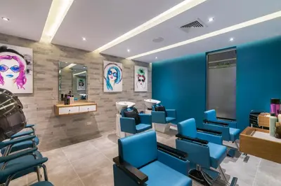 a waiting room at a salon with blue chairs at Barceló Santo Domingo in Santo Domingo