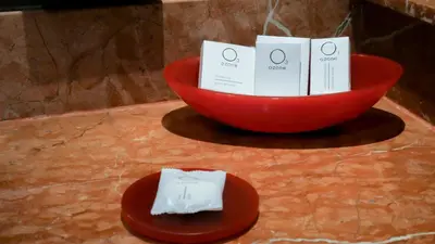 a red bowl with cards and a hat on a table at Barceló Santo Domingo in Santo Domingo