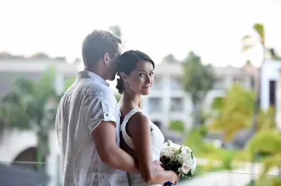 a bride and groom standing next to each other at Royalton Hideaway Punta Cana, An Autograph Collection All-Inclusive Resort & Casino - Adults Only in Punta Cana