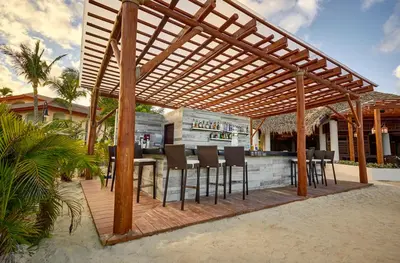 a wooden pergola on a patio with a bar at Royalton Hideaway Punta Cana, An Autograph Collection All-Inclusive Resort & Casino - Adults Only in Punta Cana