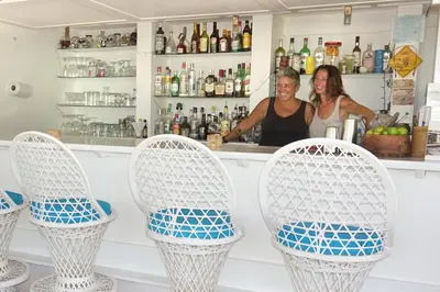 a man and a woman standing at a bar at Le BDM PLAYITA in Las Galeras