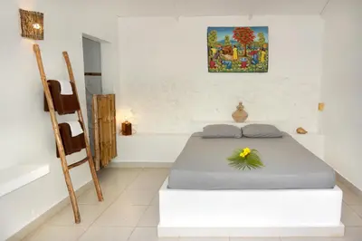 a bedroom with a bed with a flower on it at Le BDM PLAYITA in Las Galeras