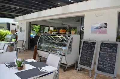 a food truck with tables and a chalkboard in front of it at Aligio Beachfront Paradise in Las Terrenas