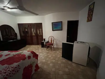 a bedroom with a bed and a tv in a room at Villa Antonia 16 in Sosúa