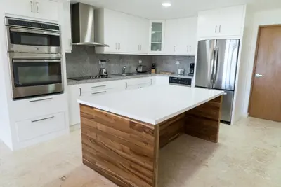 a kitchen with white cabinets and a white counter top at 3BR / 3BA Modern Paradise Loft Condo in Gated Community w/ Daily Housekeeping in Sosúa