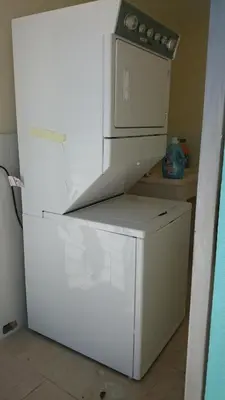 a white refrigerator with a microwave on top of it at Luxury Karla Apartments in Las Flores