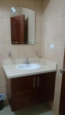 a bathroom with a white sink and a mirror at Luxury Karla Apartments in Las Flores