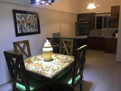a table with a vase on top of it in a kitchen at Luxury Karla Apartments in Las Flores