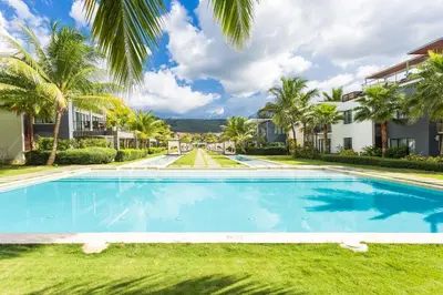 a swimming pool in front of a villa at Apartment in Sublime Samana Résidence in Las Terrenas