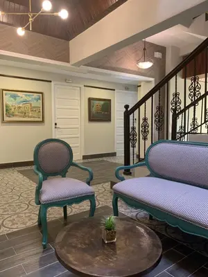 a lobby with two chairs and a table at Hotel Conde de Penalba in Santo Domingo