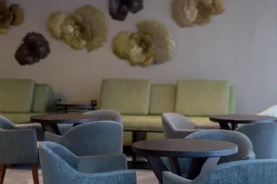 a waiting room with tables and couches and chairs at Emotions by Hodelpa Puerto Plata in San Felipe de Puerto Plata