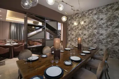 a dining room with a wooden table and chairs at Emotions by Hodelpa Puerto Plata in San Felipe de Puerto Plata
