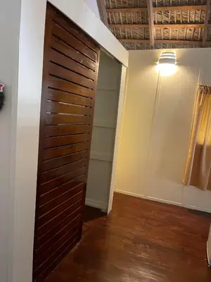 a closet with a wooden door in a room at Playa Paraiso en Magante in La Yagua