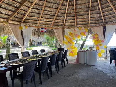 a table set up for a party under a tent at Playa Paraiso en Magante in La Yagua