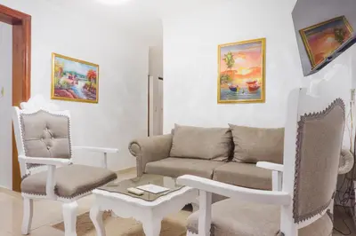 a living room with a couch and two chairs at Apartamento Los Rieles in Santiago de los Caballeros