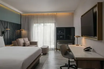 a hotel room with a bed and a desk at Courtyard by Marriott Santo Domingo in Santo Domingo