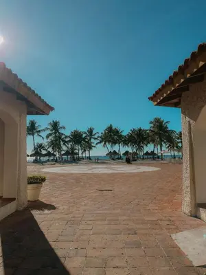 a view of a beach with palm trees and the ocean at 2BR 2BA Beachfront With View 71 in Bayahibe