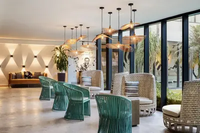 a lobby with green chairs and a couch at Renaissance Santo Domingo Jaragua Hotel & Casino in Santo Domingo