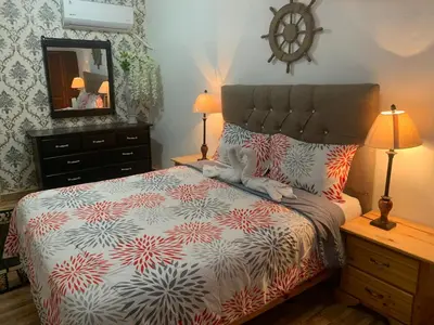 a bedroom with a bed and a dresser and a mirror at Hotel Cana Palma Zona Colonial in Santo Domingo