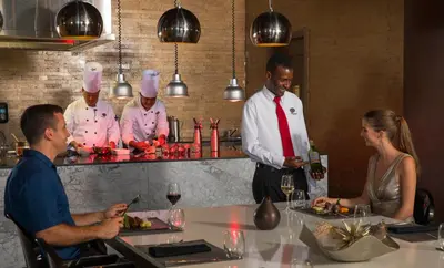 a group of chefs standing around a table in a kitchen at Royalton Bavaro, An Autograph Collection All-Inclusive Resort & Casino in Punta Cana