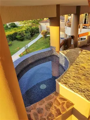 a swimming pool in the middle of a house at Luxury apartment with ocean view at the beach in Cabarete