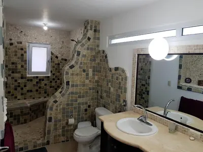 a bathroom with a toilet and a sink and a tub at Luxury apartment with ocean view at the beach in Cabarete