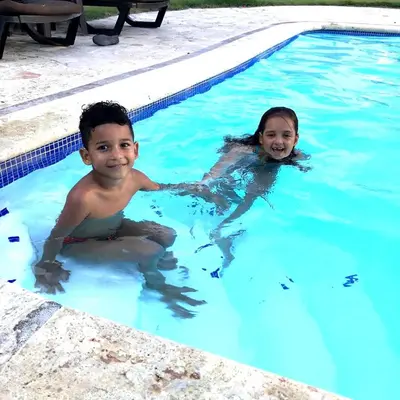 two children playing in a swimming pool at Diamond Hotel Cabarete in Cabarete