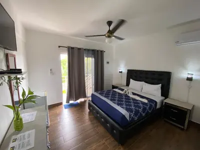 a bedroom with a bed and a ceiling fan at Diamond Hotel Cabarete in Cabarete