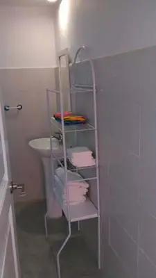 a bathroom with a towel rack next to a sink at Villa Florencia Bavaro in Punta Cana