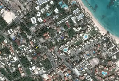 an aerial view of a complex of buildings and the ocean at Villa Florencia Bavaro in Punta Cana