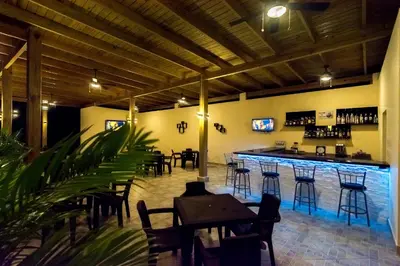 a bar in a restaurant with tables and chairs at Caribbean Diamond Boutique Hotel in Sosúa