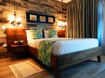 a bedroom with a bed with a wooden wall at MON Hotel Boutique in Constanza