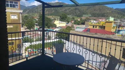 a balcony with a table and a view of a city at MON Hotel Boutique in Constanza