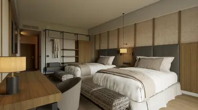 a hotel room with two beds and a desk at Santo Domingo Bay Convention Resort & Casino in Boca Chica