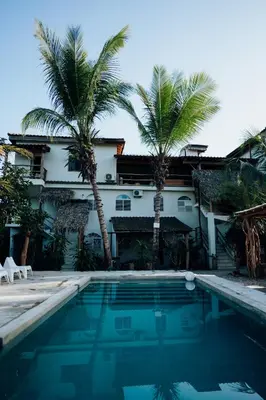 a house with palm trees and a swimming pool at Residencia El Balatà in Las Terrenas