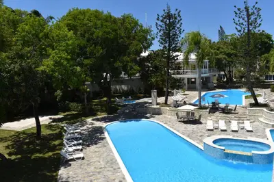 an overhead view of a swimming pool with chairs and trees at Tropical Casa Laguna in Cabarete