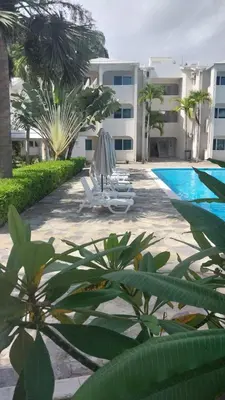 a resort with a swimming pool and a building at Tropical Casa Laguna in Cabarete