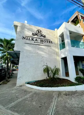 a nirvana hotel sign on the side of a building at Nilka Hotel Boutique in Santa Bárbara de Samaná