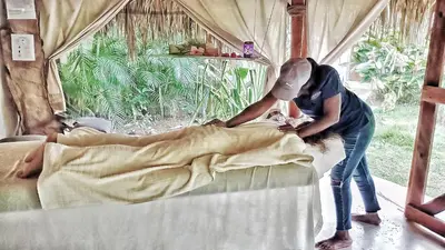 a woman standing next to a man laying on a bed at Casa Picaflor B&B in Las Terrenas