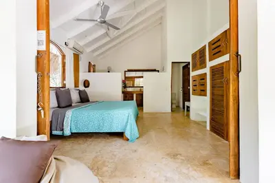 a bedroom with a bed and a ceiling fan at Casa Picaflor B&B in Las Terrenas