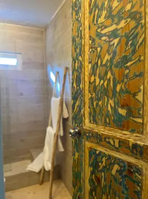 a door with a painting on it in a bathroom at Hotel Boutique Casa Grande By Playa Bonita in Las Terrenas