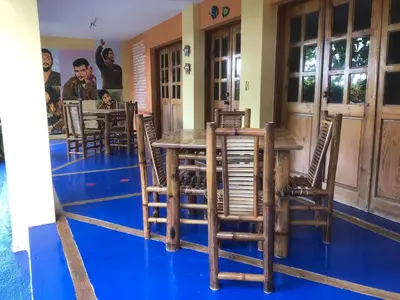 a dining room with a wooden table and chairs at La Cueva del Che in Juan Dolio
